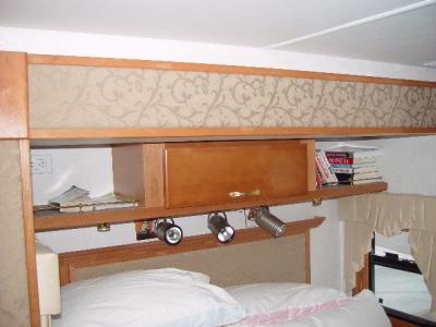 STORAGE ABOVE THE BED WITH READING LIGHTS