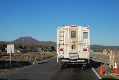 APPROACHING OUR FIRST MILITARY CHECKPOINT-NOTICE THE PLYWOOD GUARD AT THE RIGHT