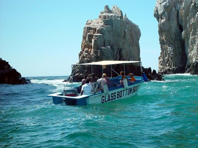  ONE OF THE GLASS BOTTOM TOUR BOATS HEADING FOR THE ARCHES AT CABO SAN LUCAS