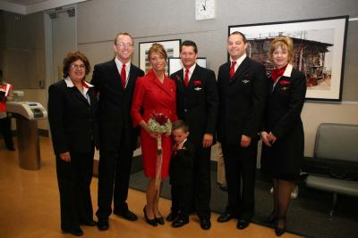 The BRIDE and GROOM with the Delta flight crew for inaugural flight (wearing brand new Richard Tyler designed uniforms)