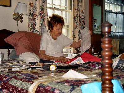 Lillie Mae in her office, checking the soap opera schedule for the upcoming month