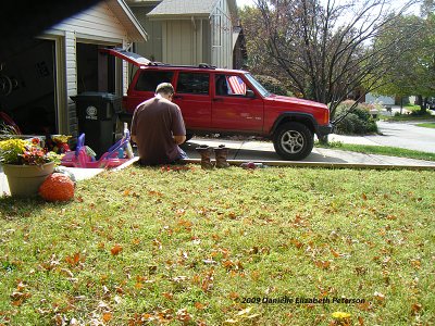 Here is Dad cleaning his shoes.  That is his Jeep before he totaled it, with me and my brother in it.