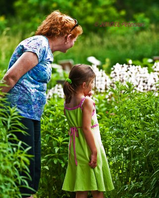 Mother and daughter enjoying an evening of looking at flowers.