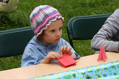 Little girl learn how to make an origami