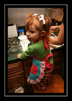 Using her new apron to help with cookies