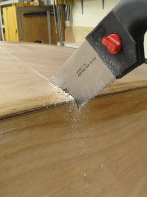And down the opposite chine; seam wedged to maintain an open kerf.