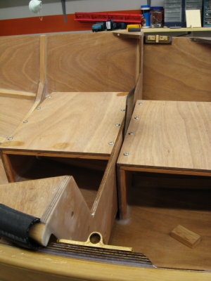 Side view of inner half butting against seat/thwart of outer; bolts under seat will hold halves in place.