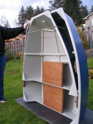 Painted and outfitted in nesting mode:  blue hull; light gray interior with bright rowing stations and rear thwart.