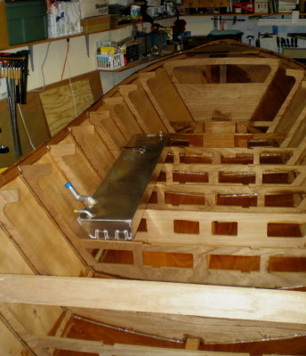 Test fit of starboard tank -- headed for the cutout area below, vent and filler exiting the hull under the deck.