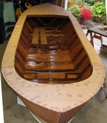 Decking completed, screwholes filled; some fairing and filling to come yet.  Hull is now stiff enough to remove jig braces.