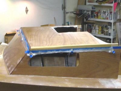 Six oz glass wetted out. Razor blade run along blue tape edge cuts glass; then pull the tape.