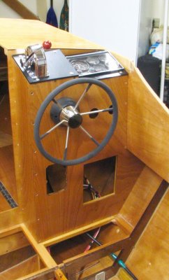 Helm closed; electrical panel left; right an access panel; fuel gauges above later.