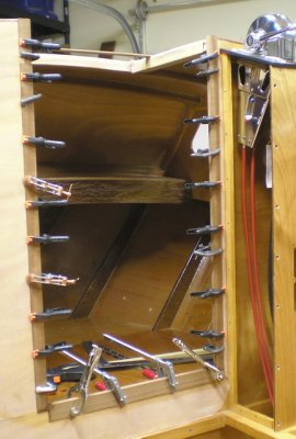 On to the cuddy access. Sapele perimeter graces opening (here in glueup) and the sliding door.
