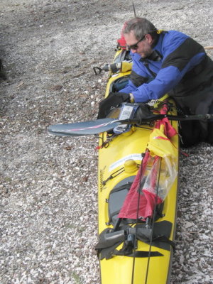 Philip, cramming gear into and onto his boat.