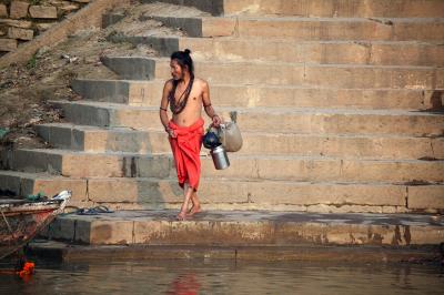 Nepalese priest stepping down to the Ganges, Varanasi.