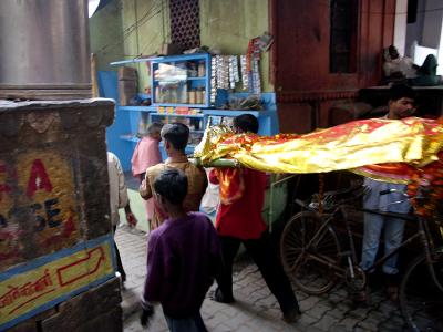 Body being brought through an alley to Manikarnika ghat, Varanasi.