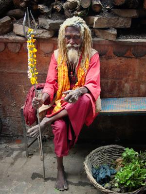 Sadhu sitting along an alley leading to Manikarnika ghat, Varanasi.