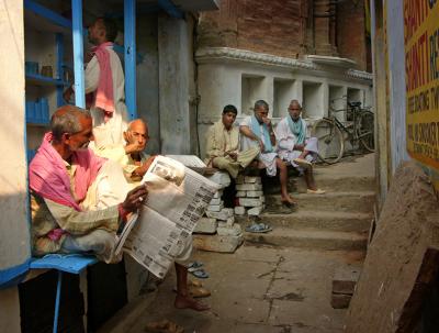 Men relaxing, talking along a tiny alley, Varanasi.