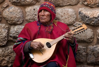 Blind musician playing for tips.