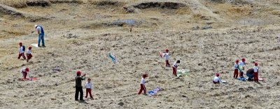 School children on an outing, flying kites.