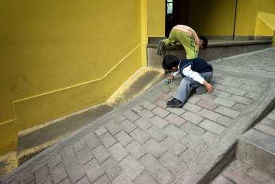Boys playing in an alley.