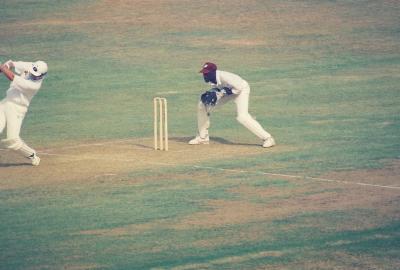 Batsman steps down the wicket to drive past the bowler