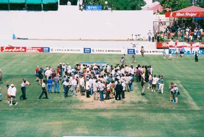 Cricket fans inspect the pitch after the Match is abandoned