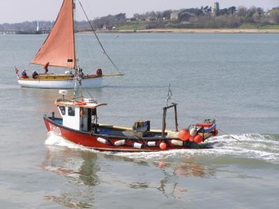Fishing Boat Arrives as Sailing Boat Gets Set to Depart