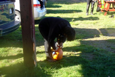 Claire weighing down her pumpkin..