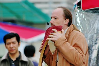 The pan flute player adding melody to the last evening of 2005