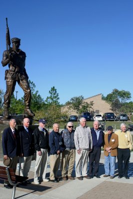 Veterans of Detachment 101 and Viscount John Slim pose for photos in front of the Special Warfare Memorial Statue Bronze Bruce outside USASOC Headquarters.