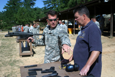 Sergeant First Class Watson instructs my father, Patrick, on the loading, unloading, and safety measures of the German-made MP5, one of four weapons the Special Forces allowed their guests to test fire at one of their target ranges.