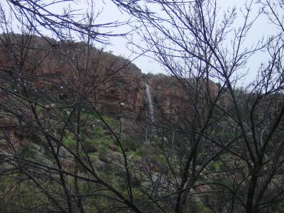 Waterfall falling from cliff south of suspension bridge