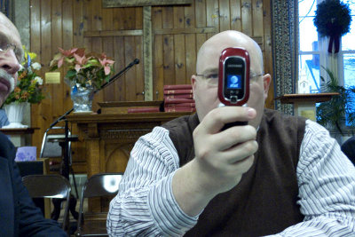 Larry tries to show George how to use his camera phone.