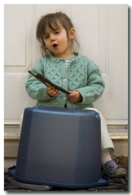 Lorelei upends the bucket to drum and sing and...