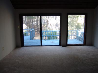 Looking across the master bedroom out onto the deck and yard