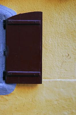 The brown window, the yellow wall and a little of blue