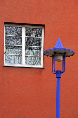 The blue lamp, the red wall, the white window
