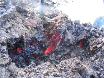 New lava bomb with crystals pulling hot lava.JPG