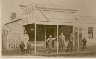 J Bell (Boot) Maker - location unknown. Young Oswald has his hand on his waist