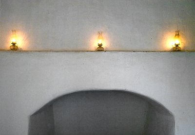 Three coal oil lamps on the mantel