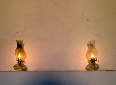 Altar room, coal oil lamps lit on mantel