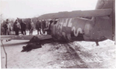A picture taken from the opposite side showing the dead pilot lying on the left wing.
