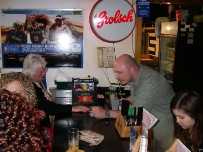 Joanie giving the bartender her last card