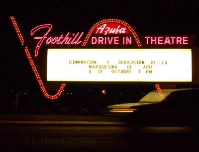 A car passes the historic Foothill Drive-In sign in Azusa, California on the night of its re-illumination, October 8th, 2007.