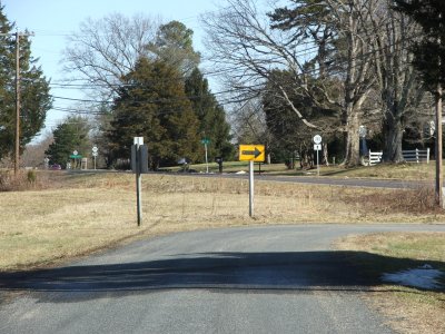 Narrow Gauge Rd. former railroad grade heads east across Rt. 20 and into front yards.