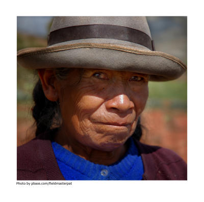 Farmwoman in blue sweater.