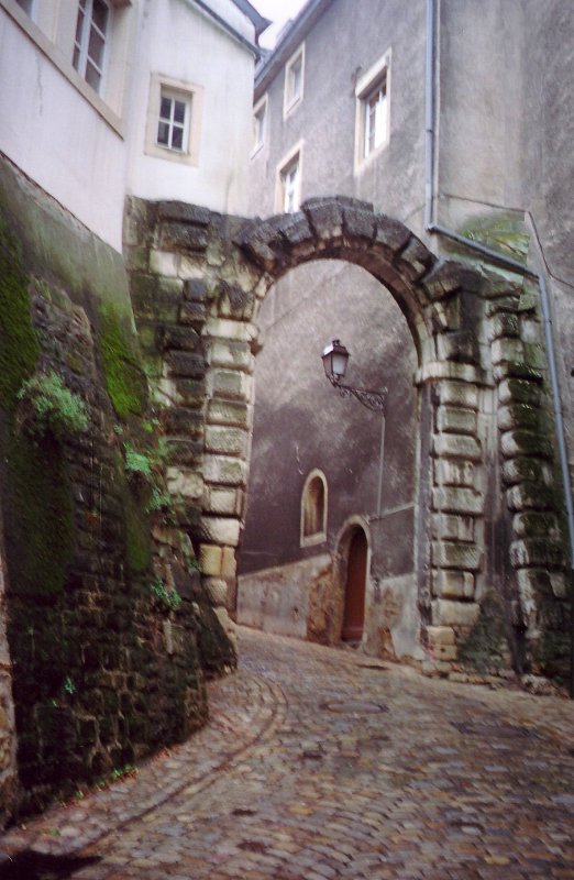 Pathway leading from the Upper Town to Lower Town with a stone gate in the background.