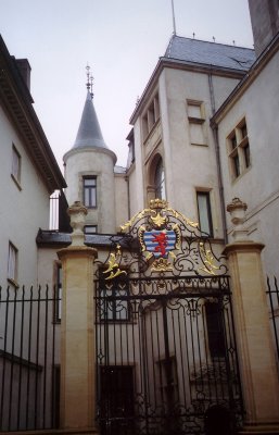 Iron gates adorned with the coat of arms of Luxembourg.