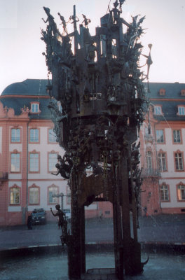 Closer shot of the Tower of Fools sculpture with water spouting from it.